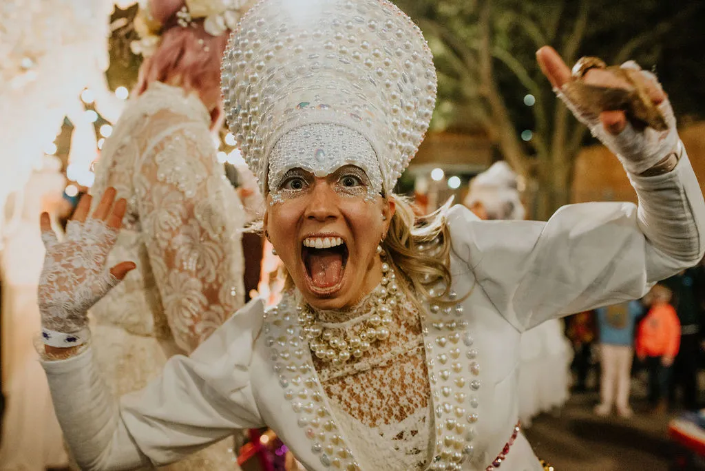 Photo of excited costumed marcher posing during Krewe de Canailles parade in downtown Lafayette Louisiana.